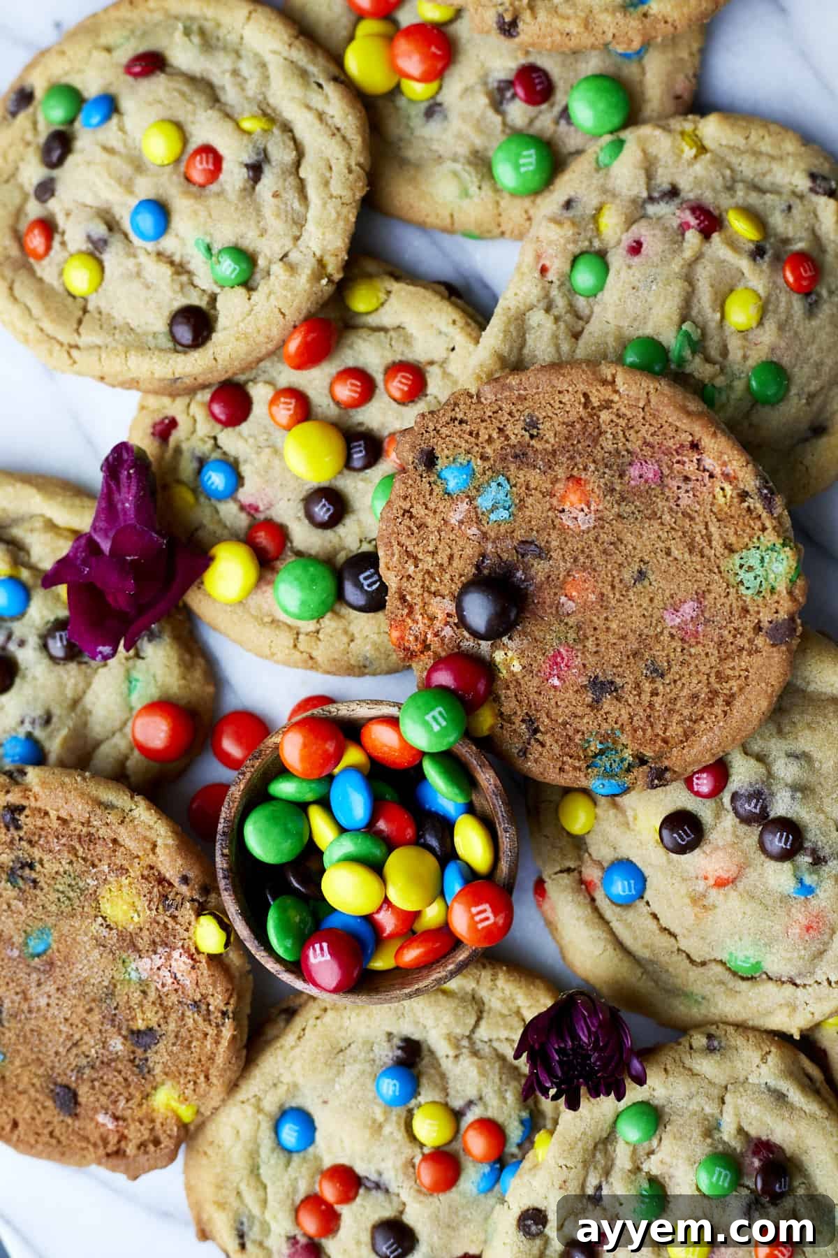 A stack of freshly baked soft-baked M&M cookies, vibrant with colorful candies and a perfect chewy texture.