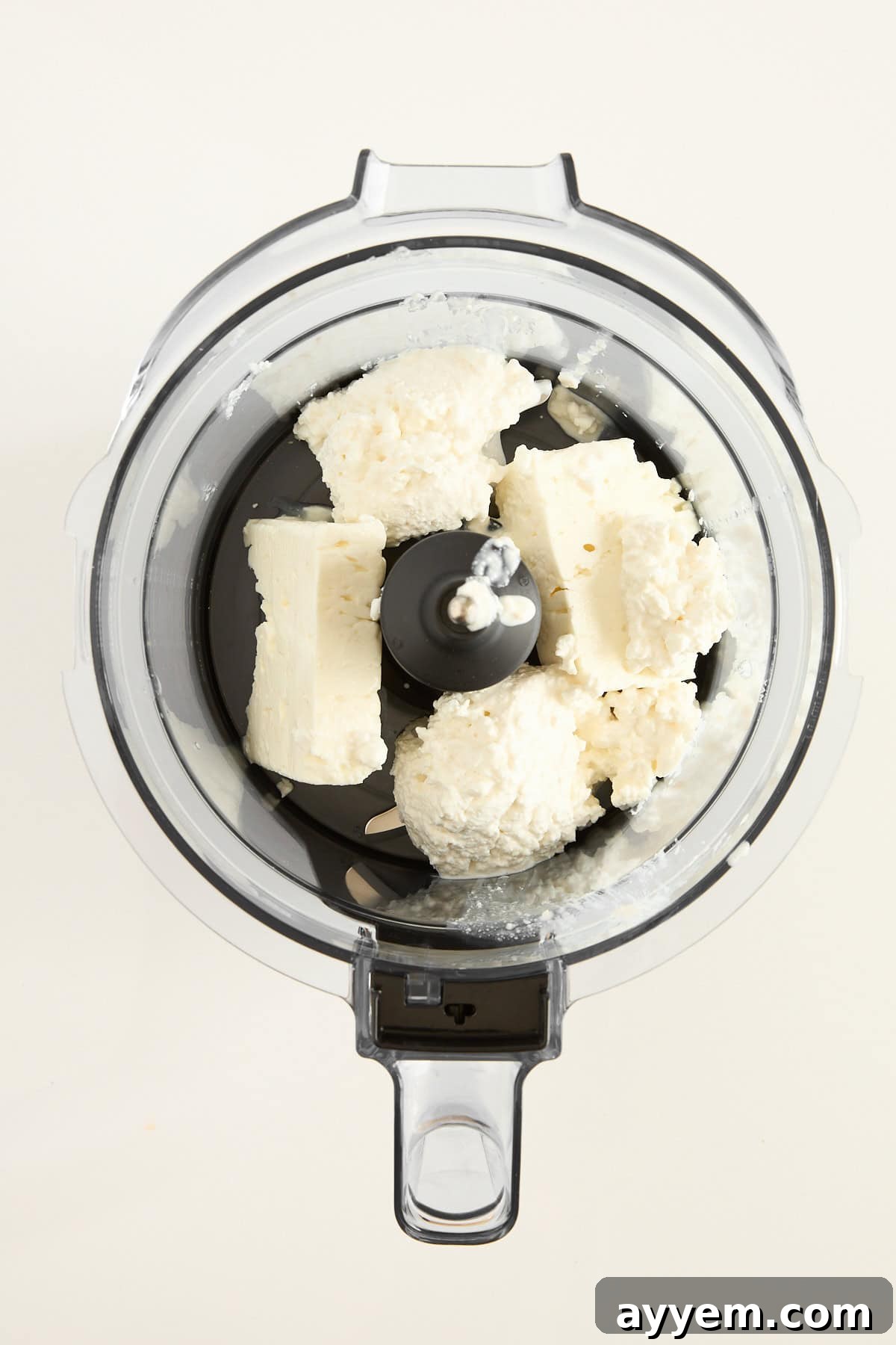 Whipped feta ingredients in a food processor.