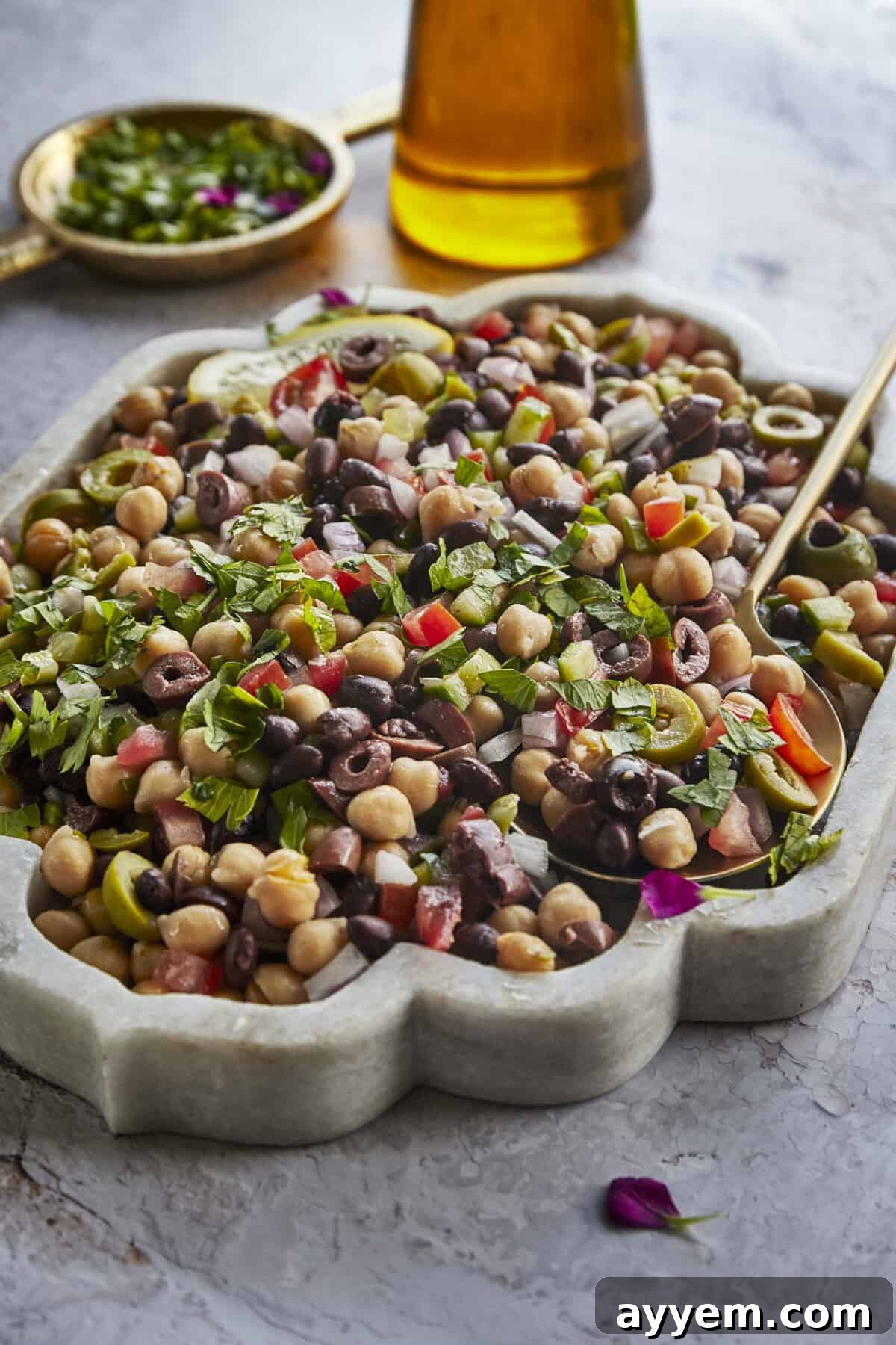 A bowl of Greek cowboy caviar with a spoon sticking out. 