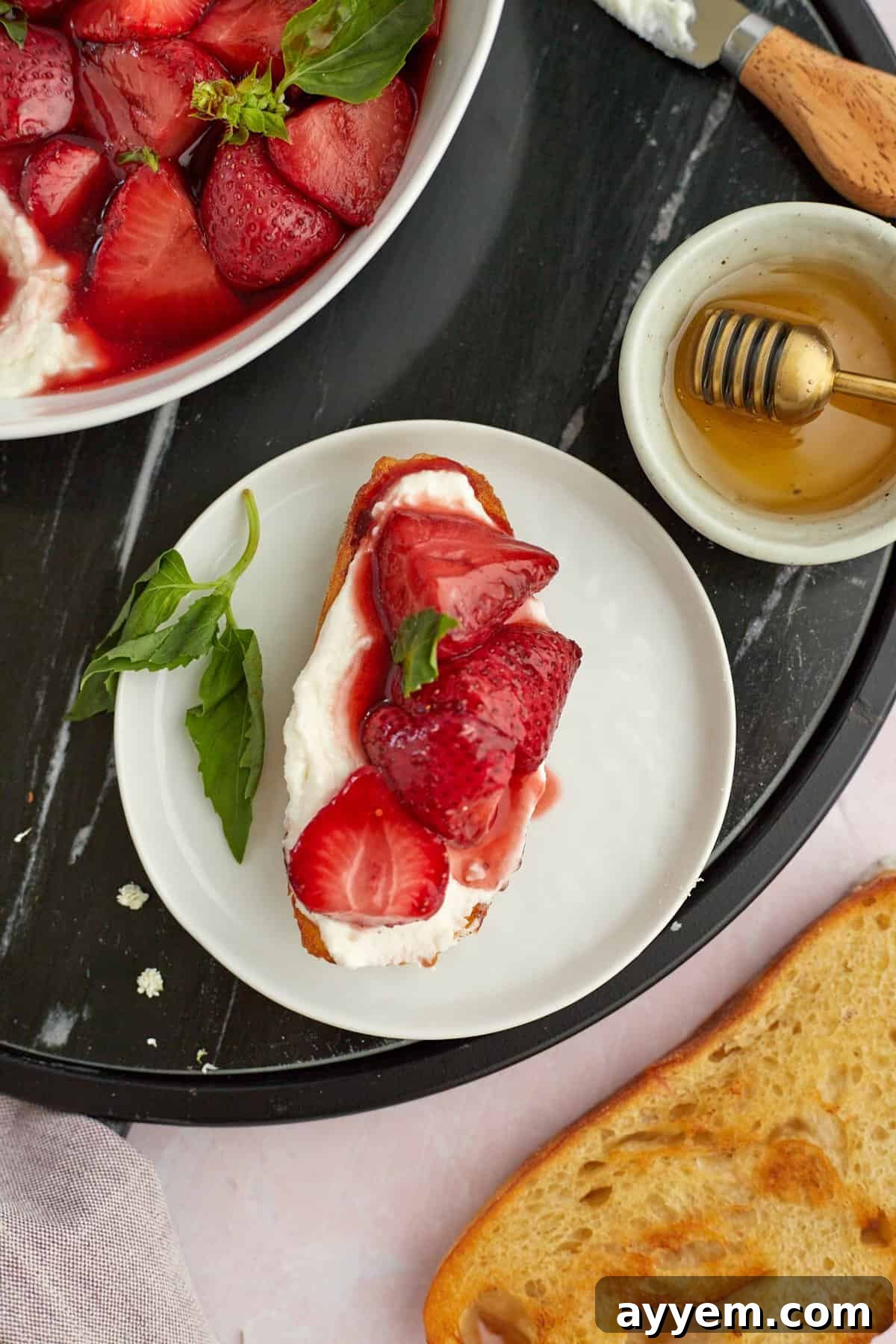 Whipped Goat cheese on toasted baguette with baked strawberries