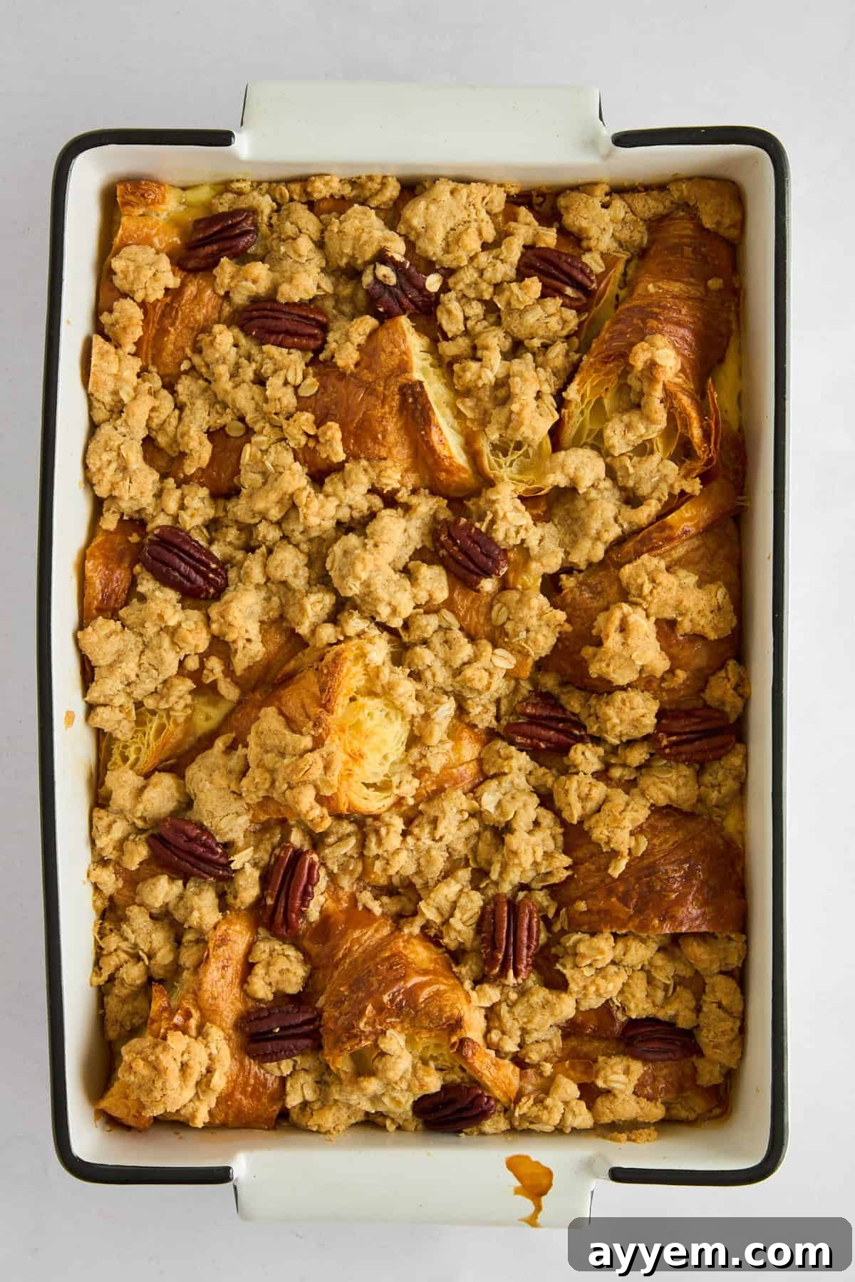 Decadent Pecan Croissant Pudding 6 Adding pecan topping to croissant bread pudding.