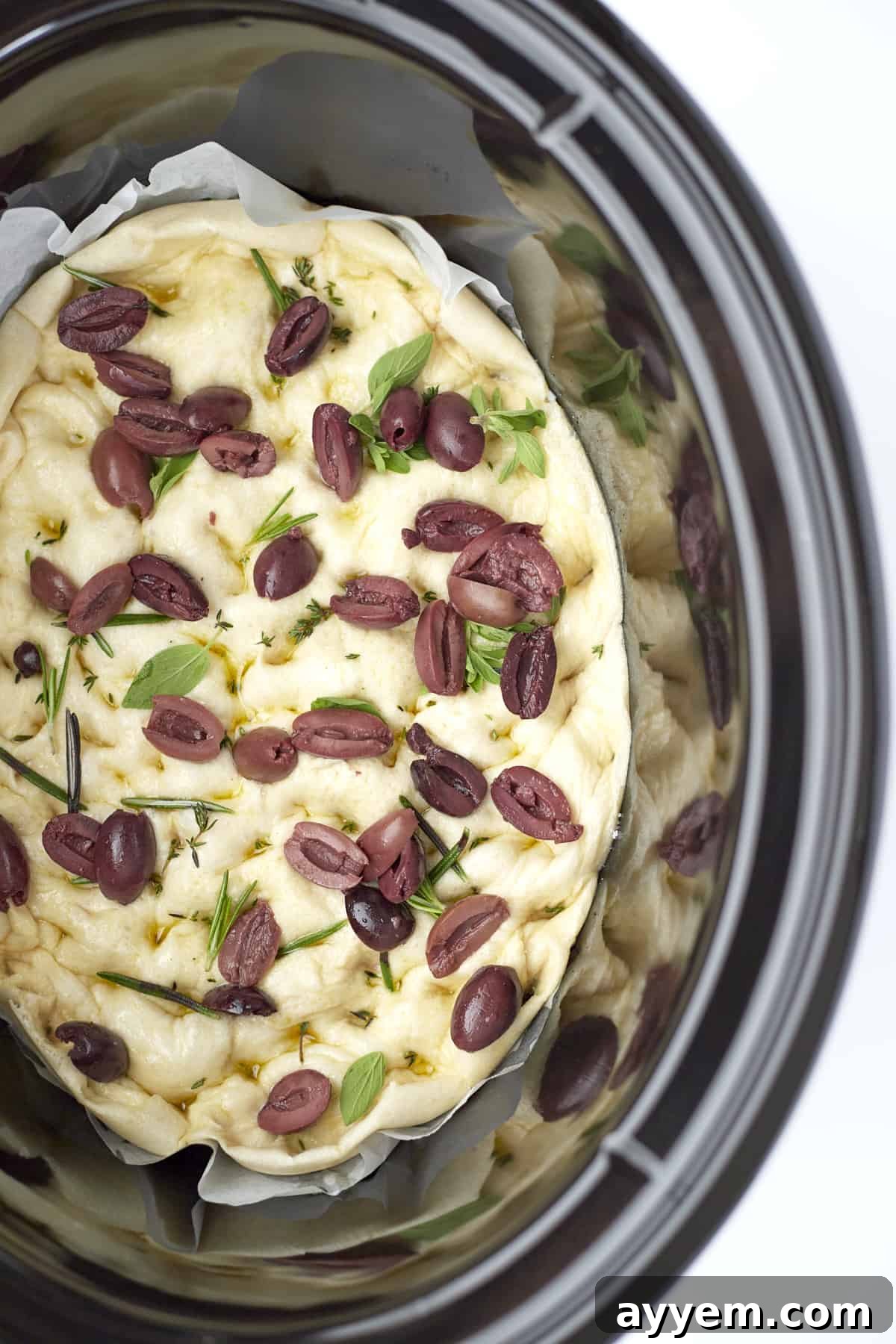 baked easy focaccia with olives in a slow cooker, ready to be served