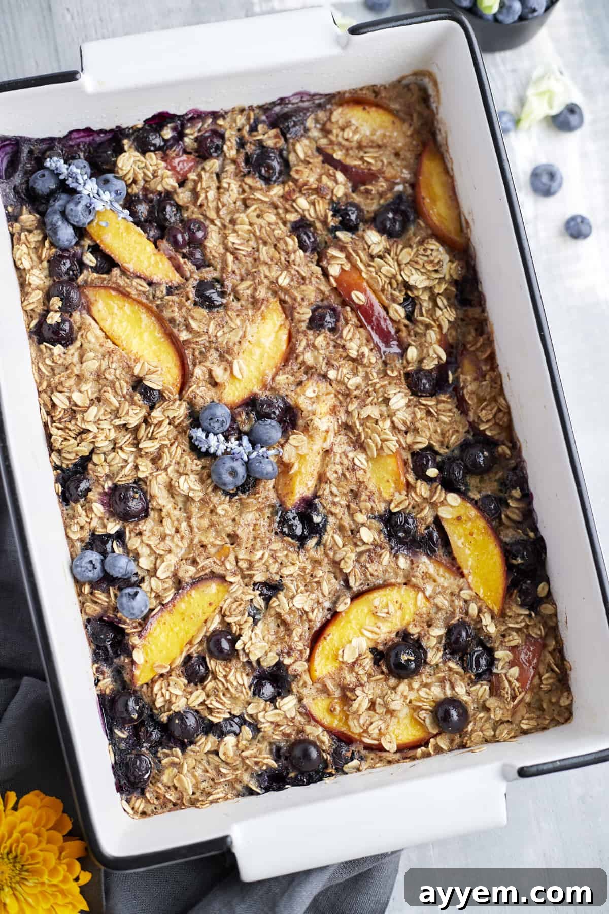 Overhead image of a rectangular baking dish full of peach blueberry baked oats