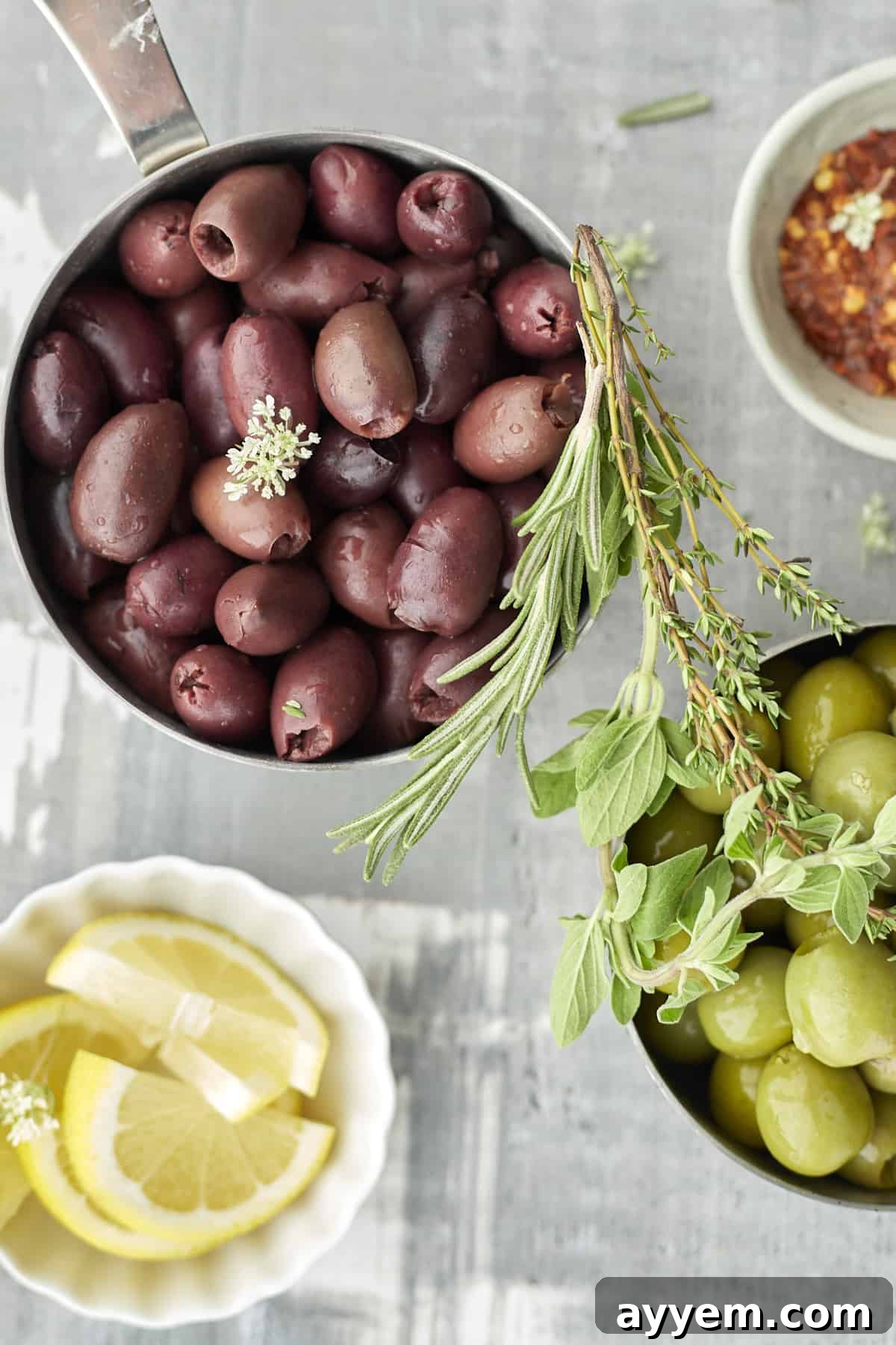 red olives, green olives, spices, and lemon wedges