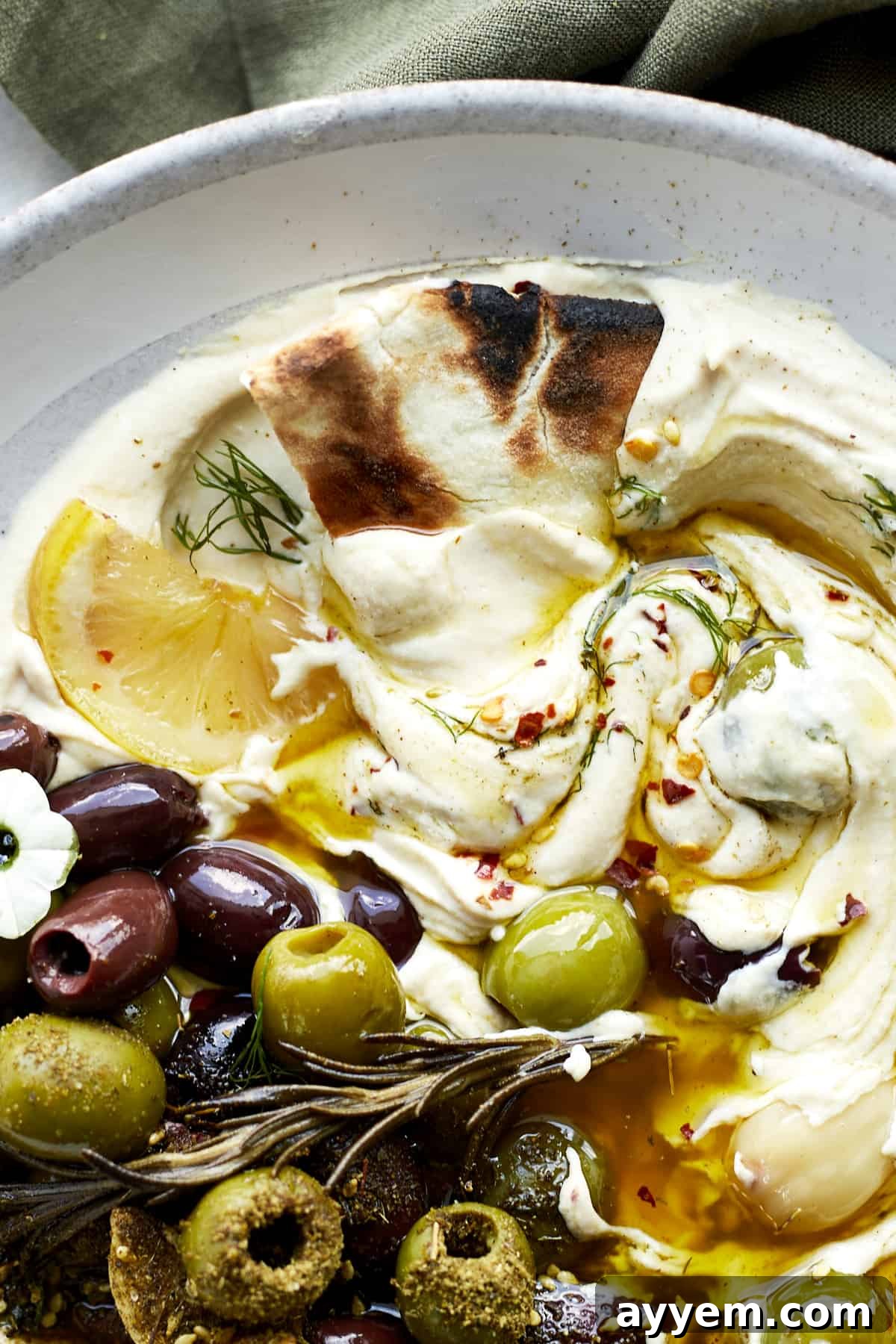 Make extra savory, ultra delicious roasted olives in the slow cooker for an easy snack or simple appetizer that can't be beat! 
