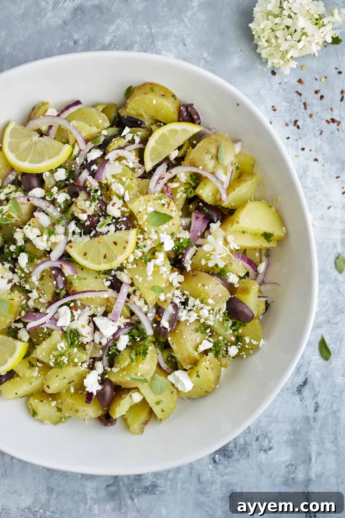 A vibrant bowl of lemon Greek potatoes with fresh herbs