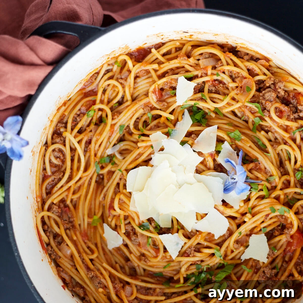 A pot full of one pot spaghetti recipe with ground beef topped with Parmesan cheese.