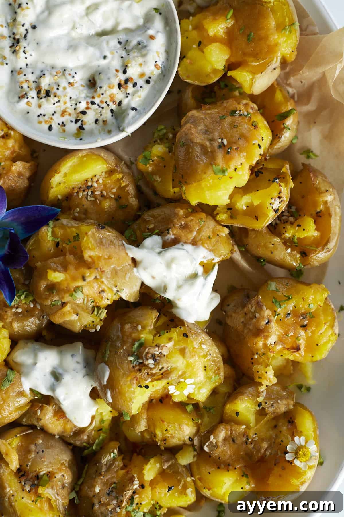The Ultimate Crispy Smashed Potatoes 4 close up image of a pile of smashed potatoes.