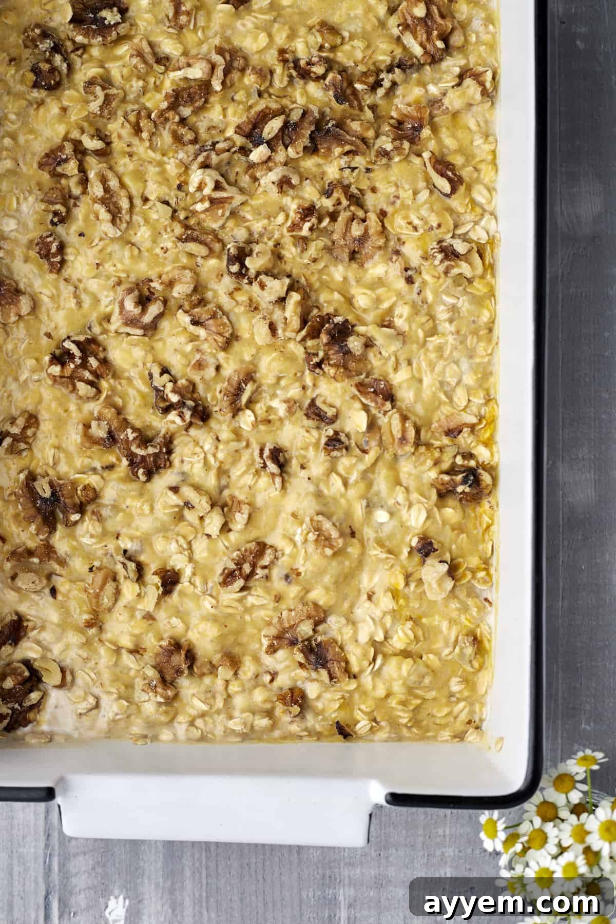 Unbaked pumpkin oatmeal mixture with nuts visible, ready for the oven.