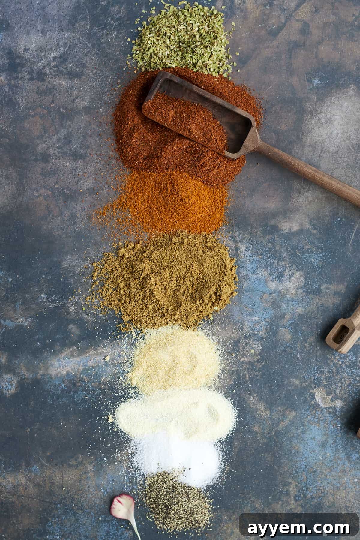 Rows of individual spices laid out, showcasing the vibrant ingredients used for homemade taco seasoning.