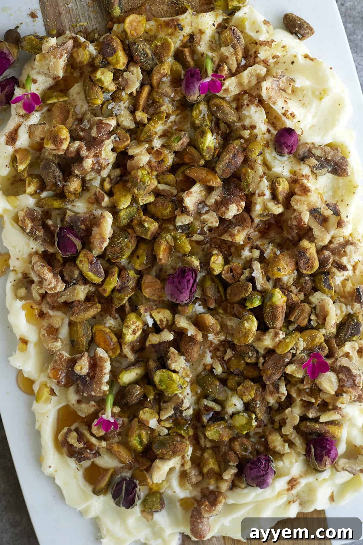 close up image of baklava butter with roasted walnuts, pistachios, honey, cinnamon, and salt