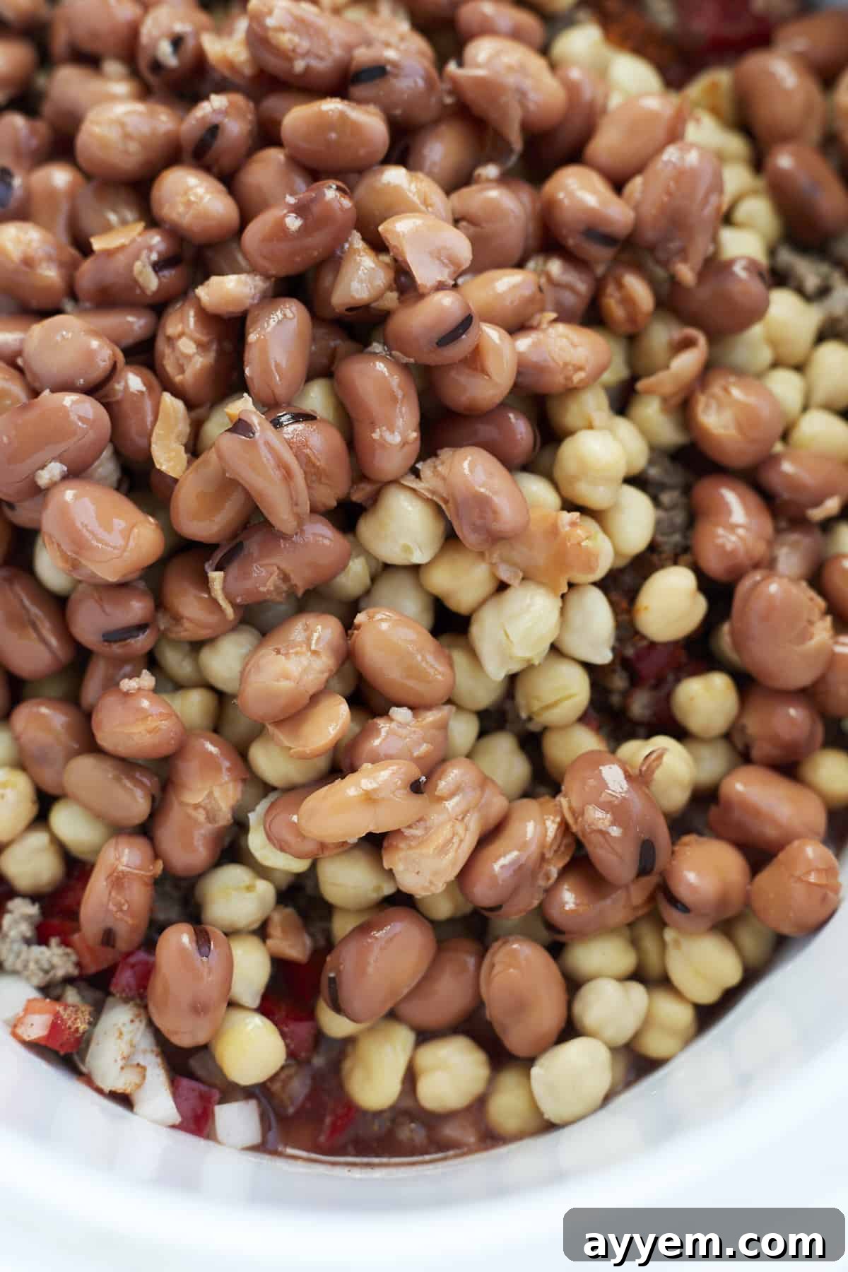 Close up image of fava beans and chickpeas, highlighting the key legumes in the Middle Eastern Beef Chili recipe.