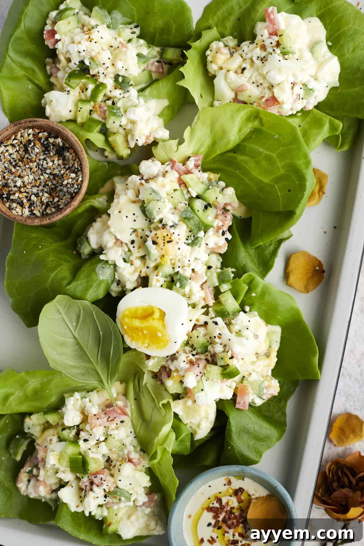 Crisp lettuce wraps filled with the delicious and healthy egg salad, garnished with fresh herbs.