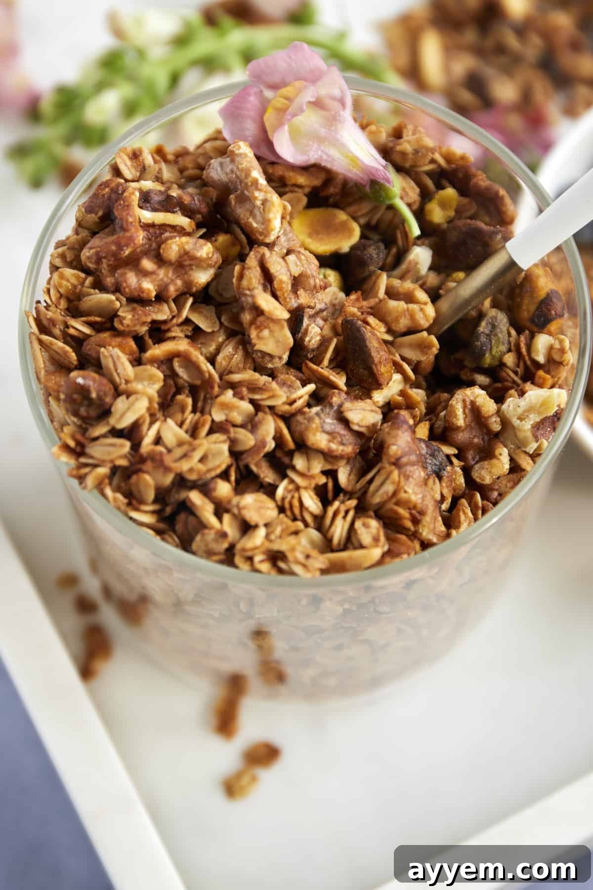 A close-up shot of a glass jar filled with freshly made Baklava Granola, ready for serving or gifting.
