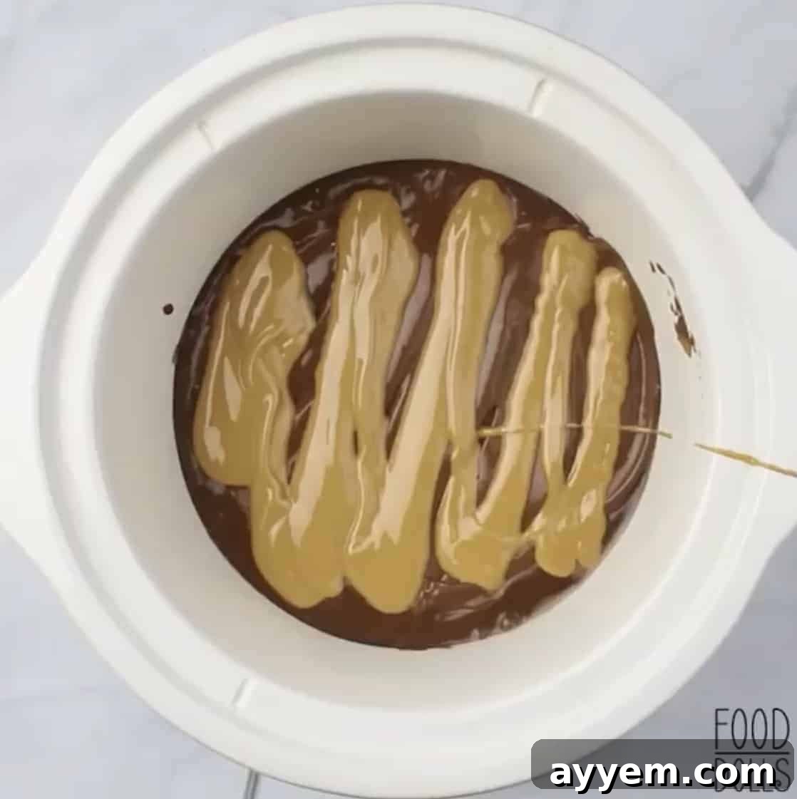 Slow cooker peanut butter lava cake with a spoon scooping out a gooey center.
