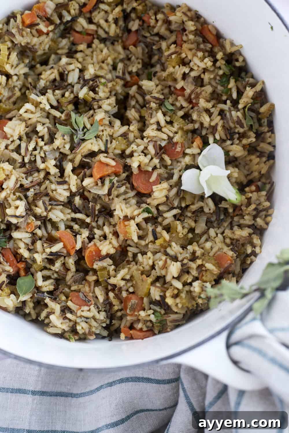 A vibrant bowl of wild rice pilaf brimming with fresh vegetables and herbs, ready to be served.