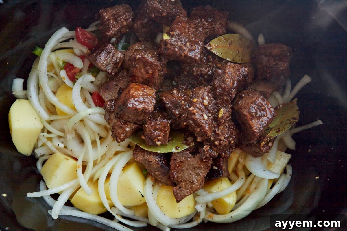 Beef stew ingredients in a crockpot.