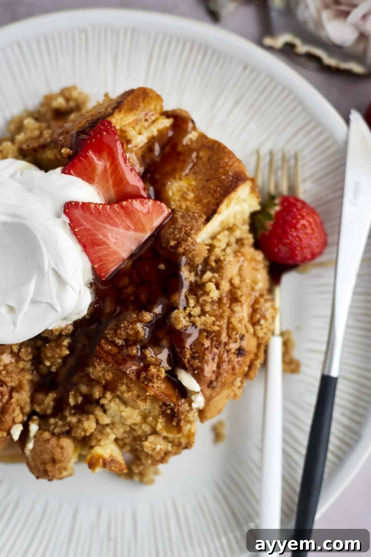 Golden brown Cinnamon Crunch Bagel French Toast Casserole in a serving dish, ready to be enjoyed.