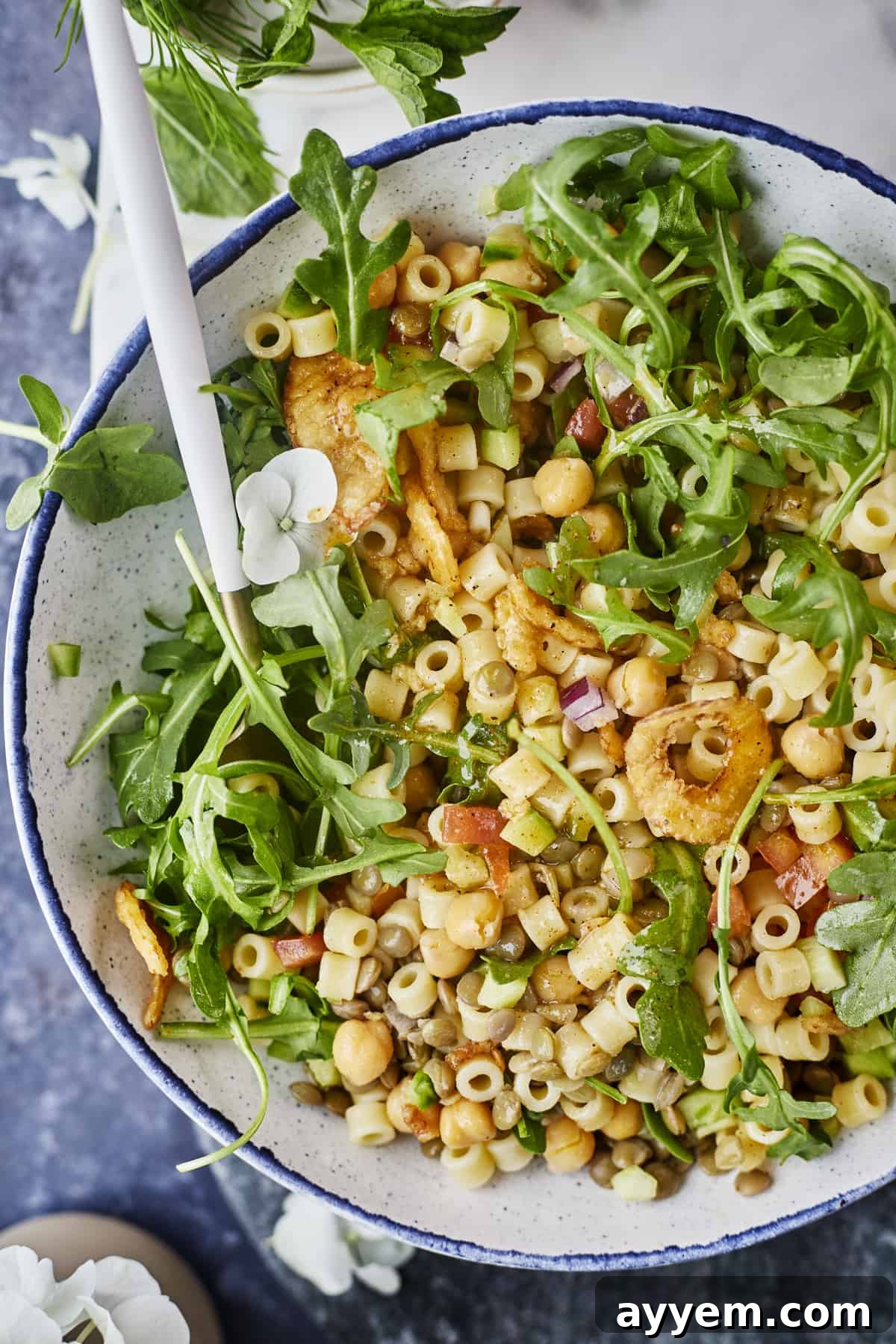 A close-up of the Chickpea and Lentil Salad, showcasing the texture of the fried onions on top.