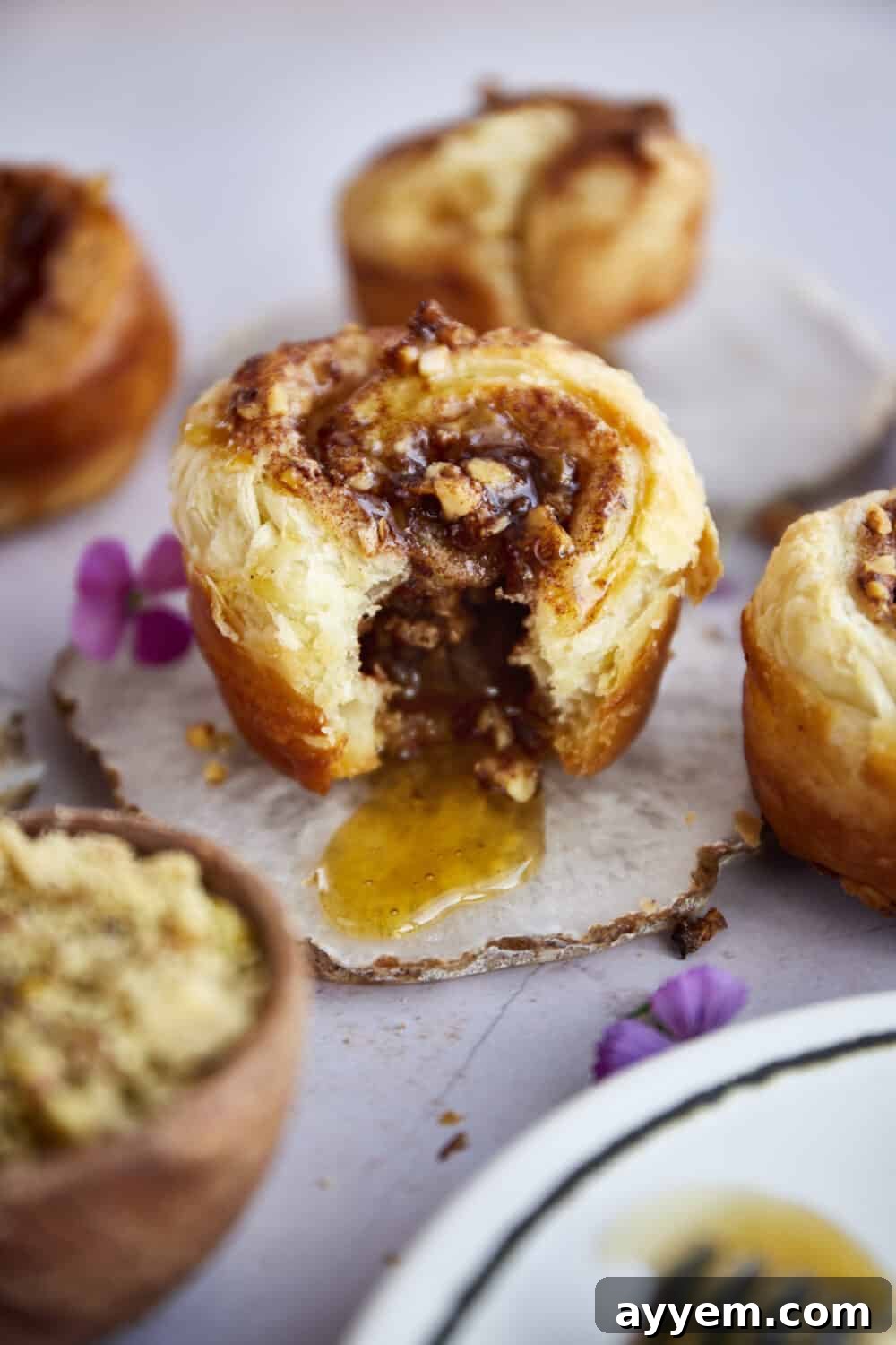 Stack of Baklava Puff Pastry Cinnamon Rolls drizzled with honey, ready to serve.