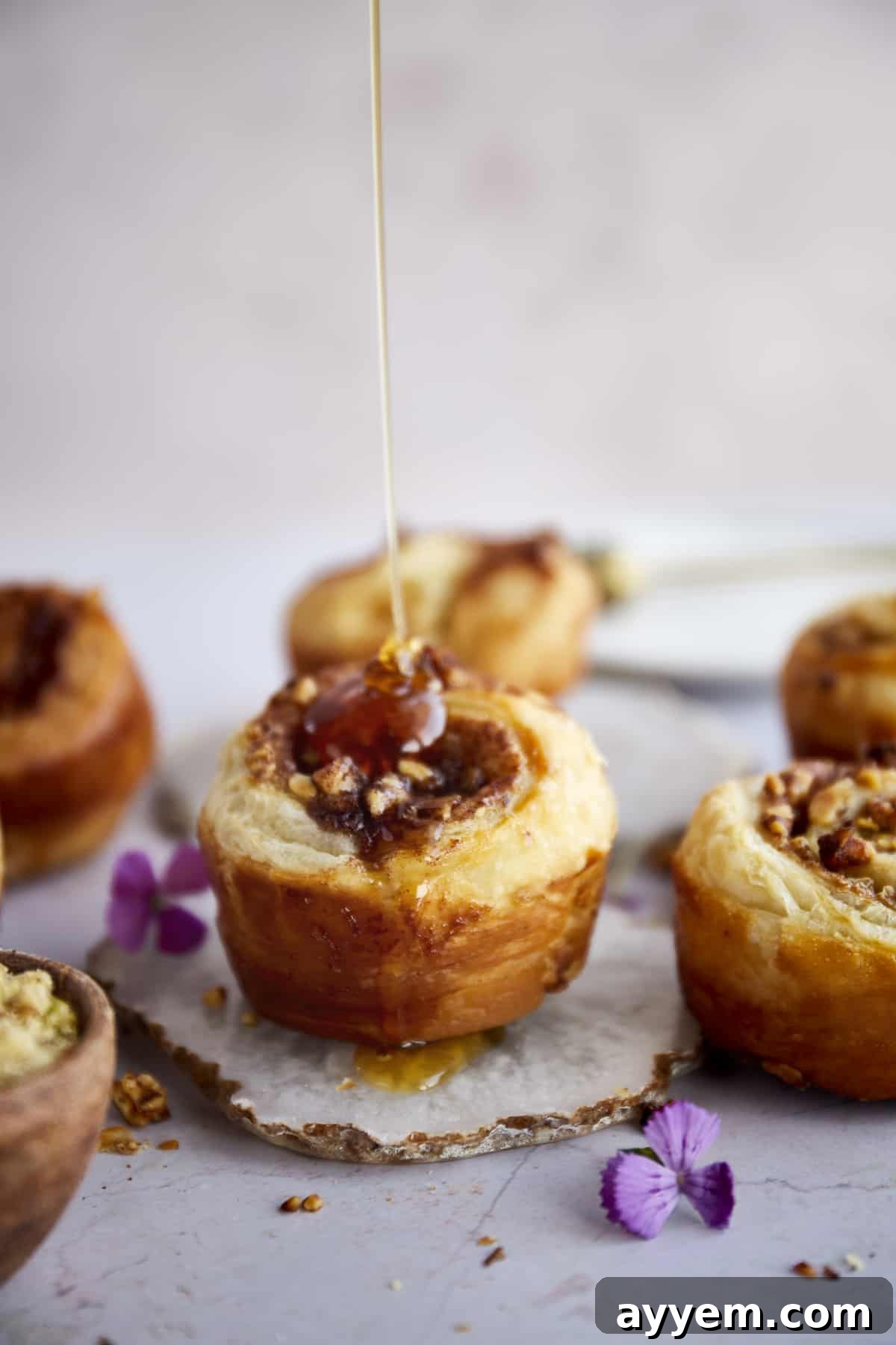 Baklava Puff Pastry Cinnamon Rolls topped with honey.
