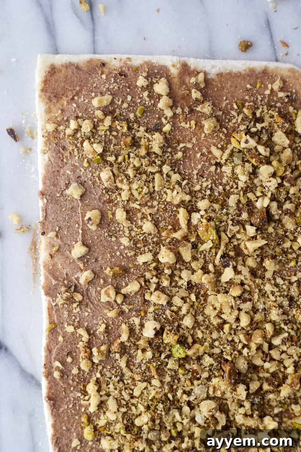 Preparation step 3: Chopped nuts sprinkled over the cinnamon sugar.