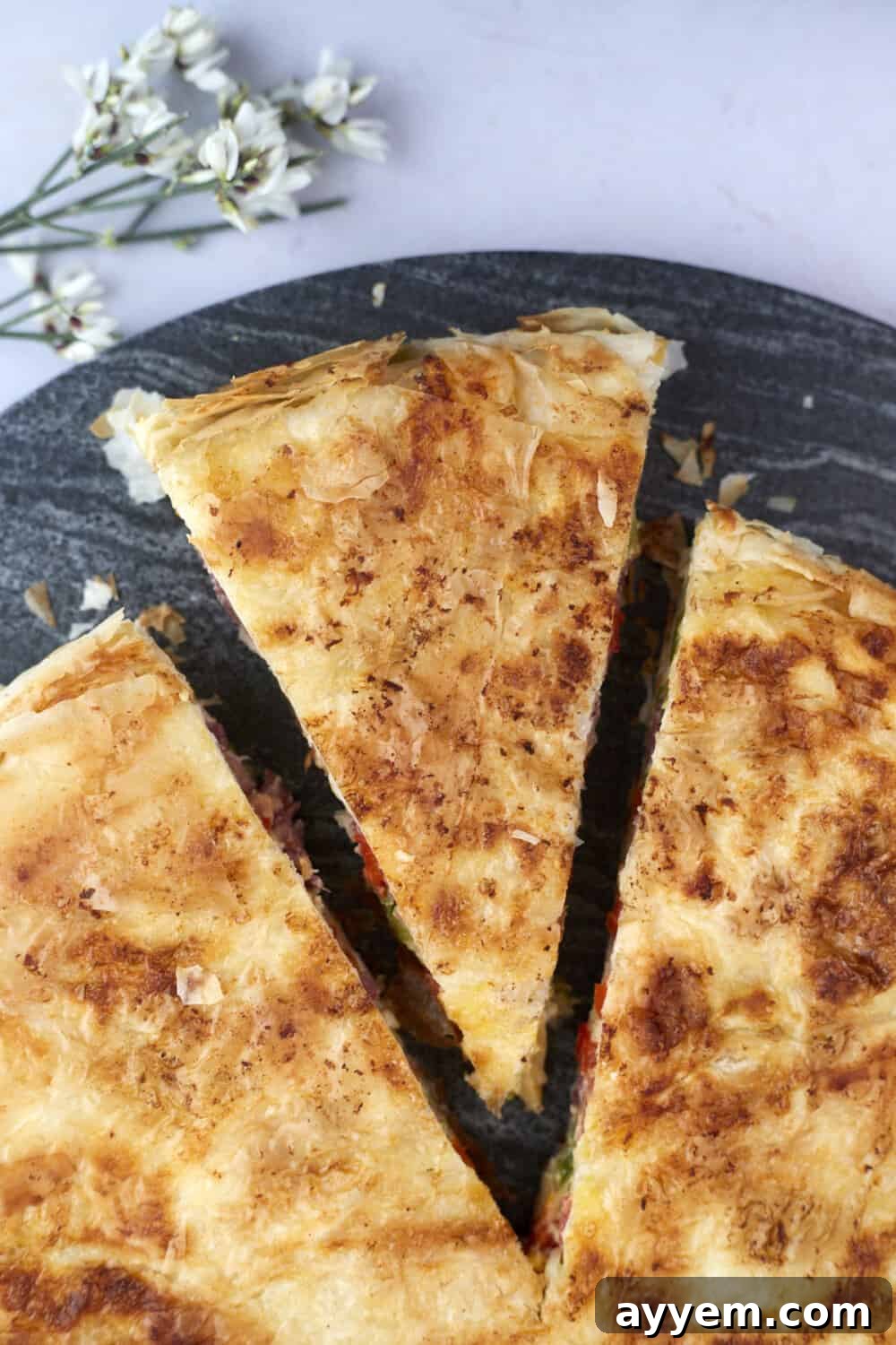 A perfectly portioned slice of Skillet Veggie Phyllo Pie, showcasing the vibrant vegetable and cheese filling within its flaky golden crust.