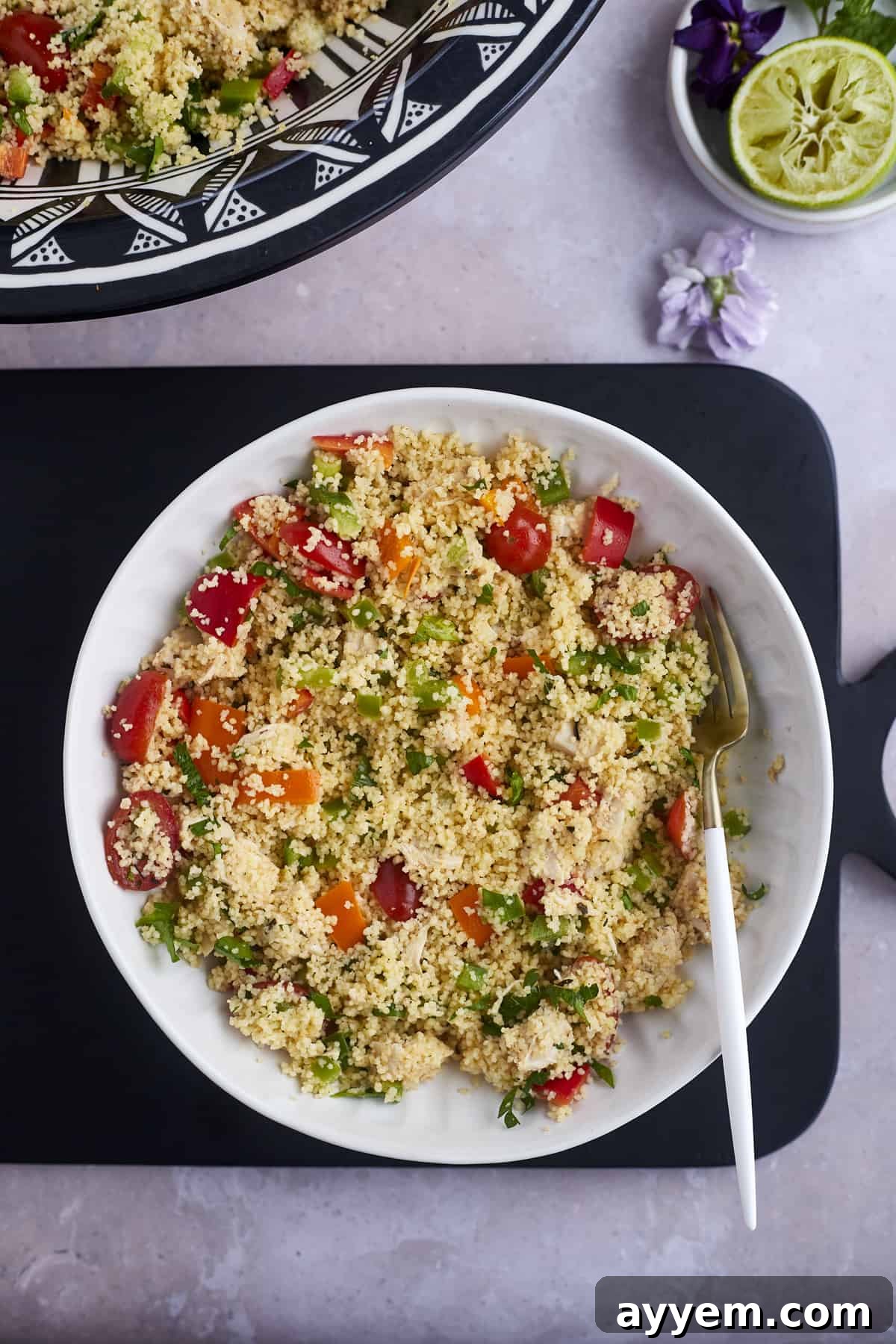 a bowl of couscous salad with chicken