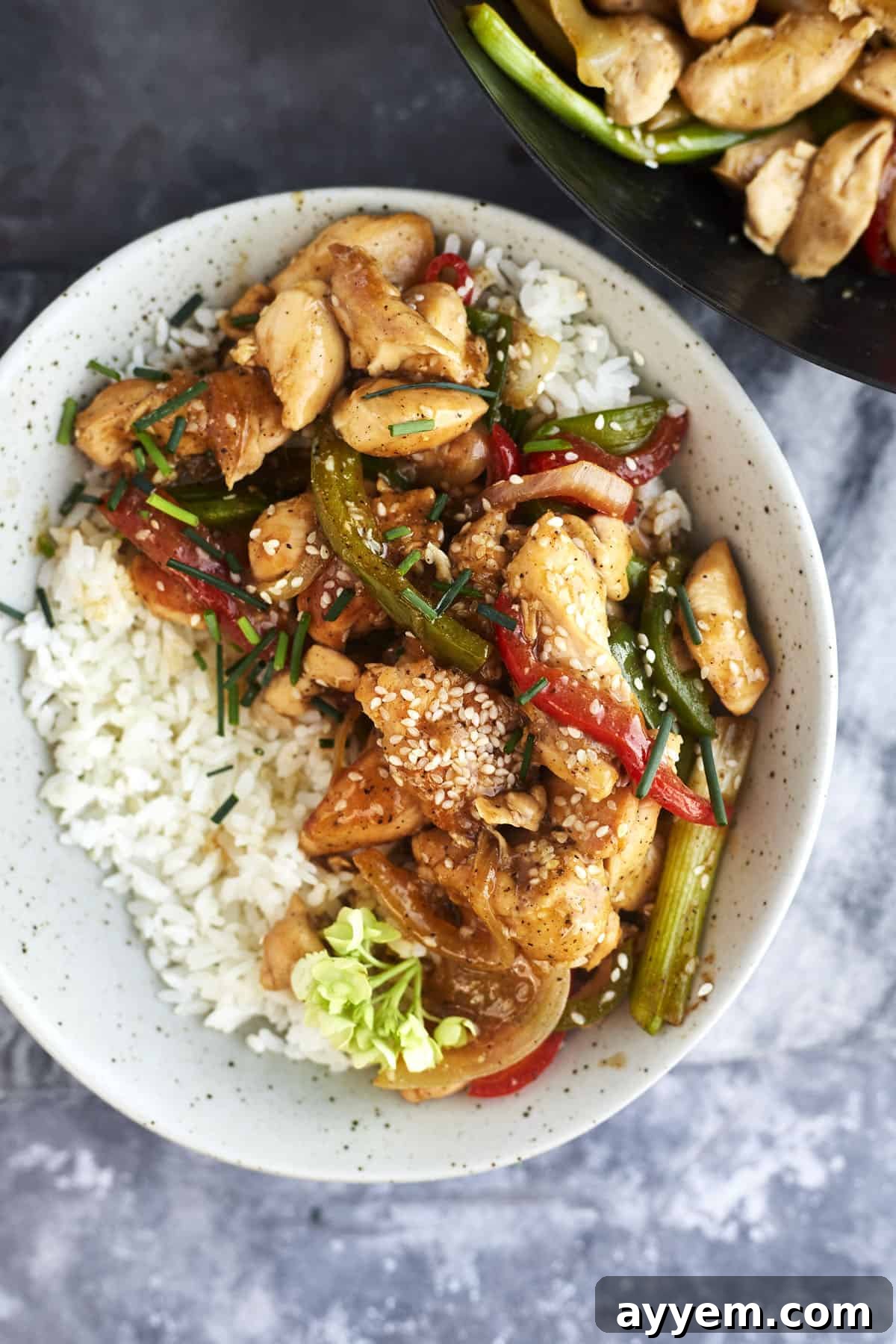 a bowl of white rice topped with black pepper chicken