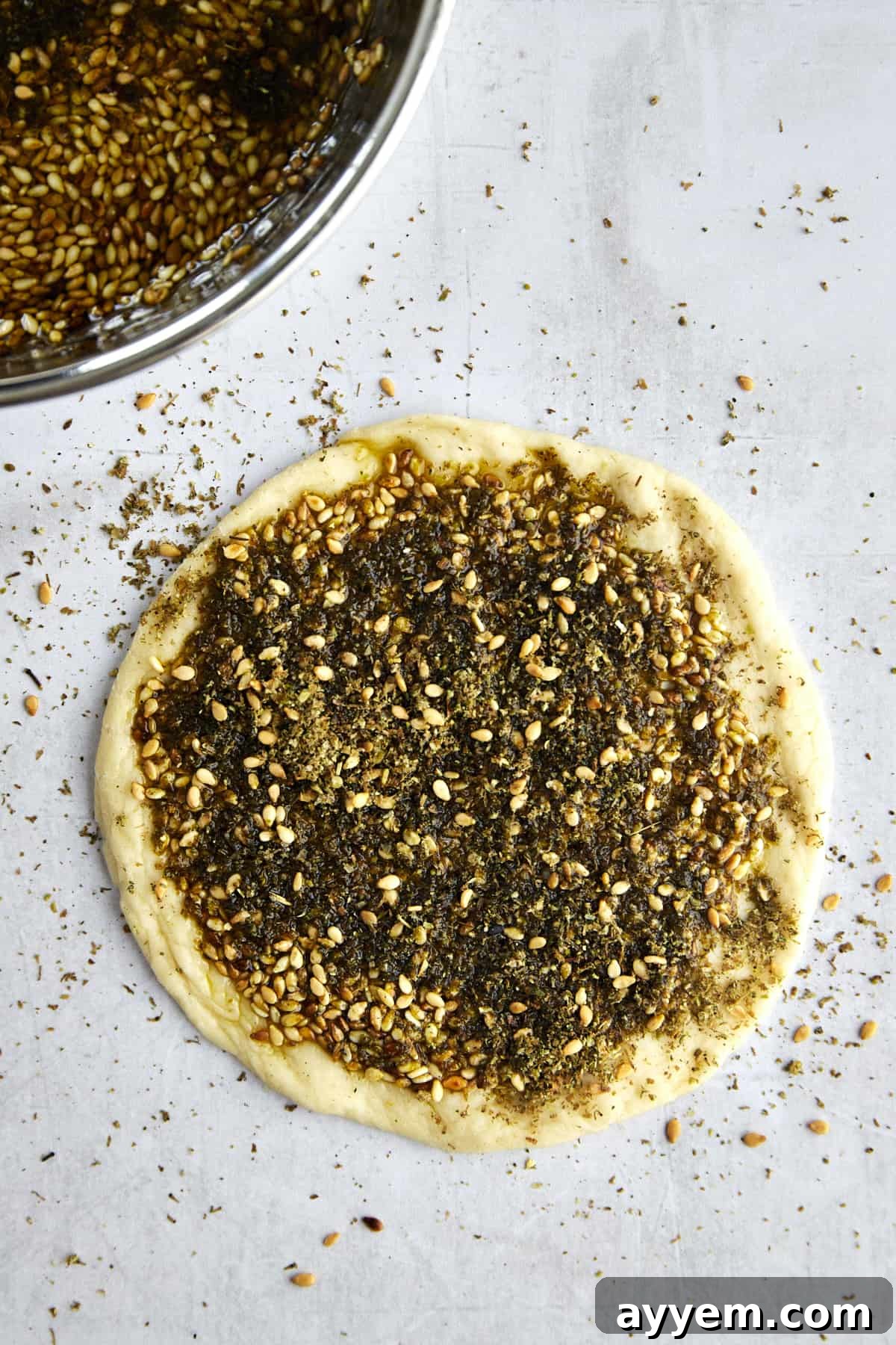 Lebanese Flatbread Wonders 7 Step 4: Brushing the za'atar and olive oil mixture onto a flattened dough disc.