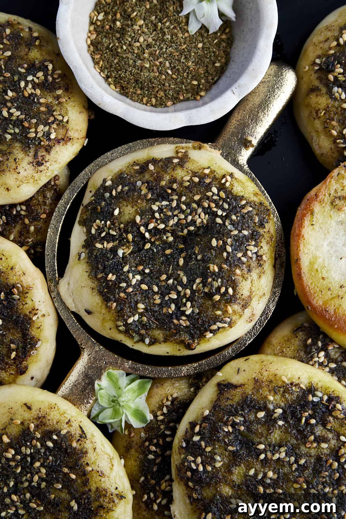 Lebanese Flatbread Wonders 10 A close-up of a beautifully baked Manakeesh topped with za'atar and olive oil, ready to be served.