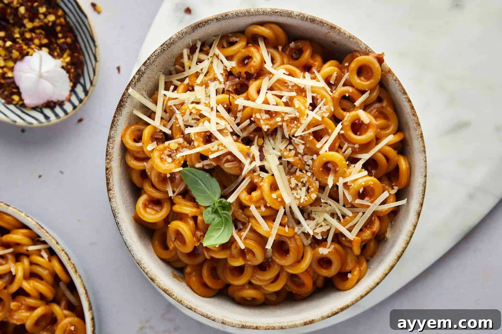 a bowl of homemade spaghetti o's topped with Parmesan