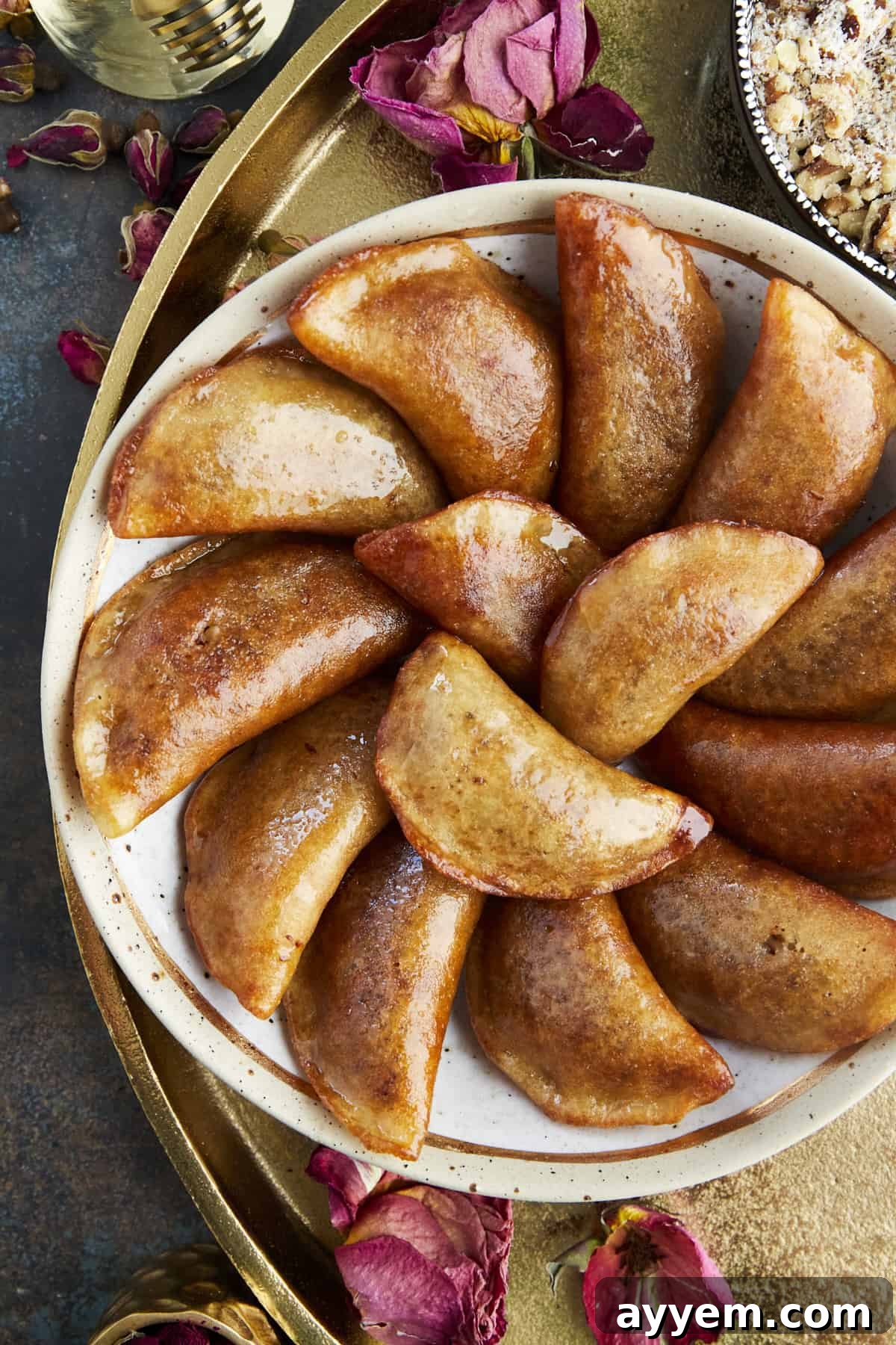 A plate of freshly made Qatayef with nut filling, generously dipped in simple syrup.