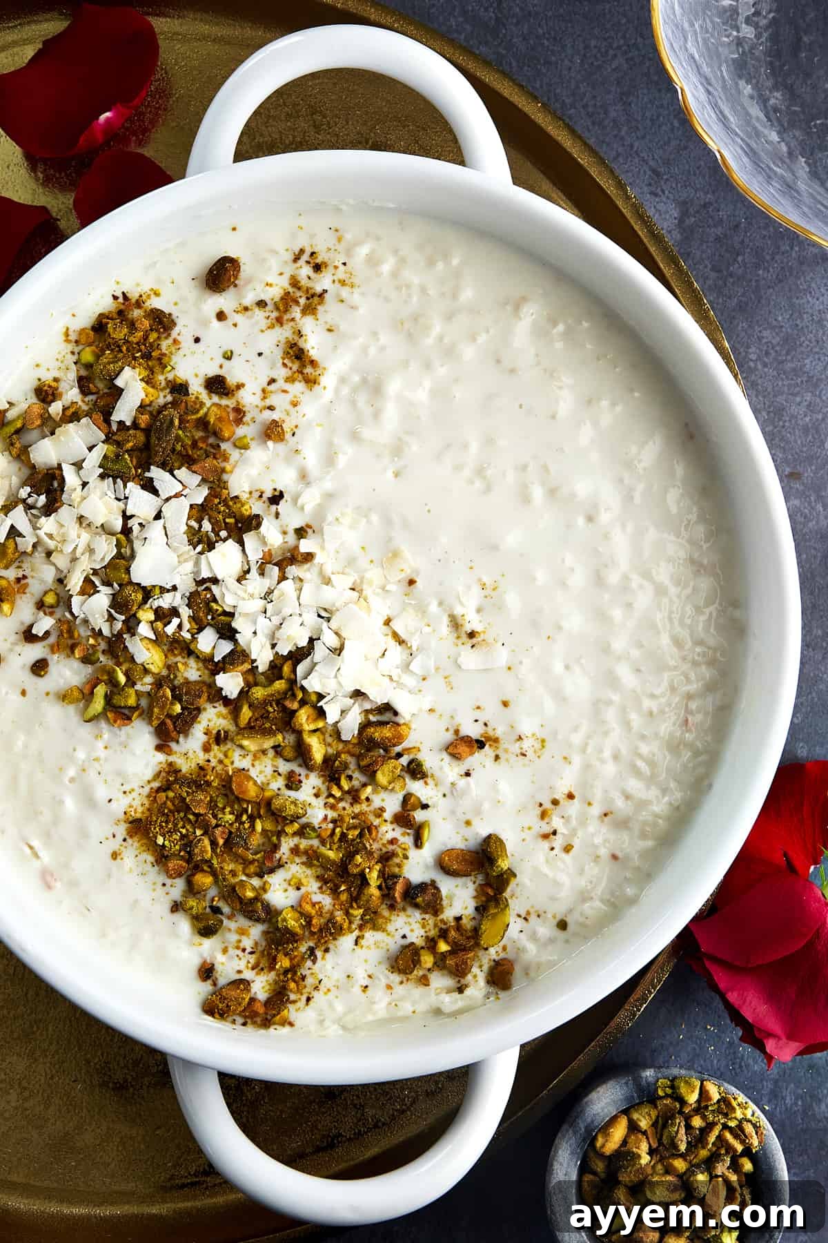 A bowl of creamy Roz Bil Laban, garnished with a sprinkle of cinnamon and chopped pistachios.