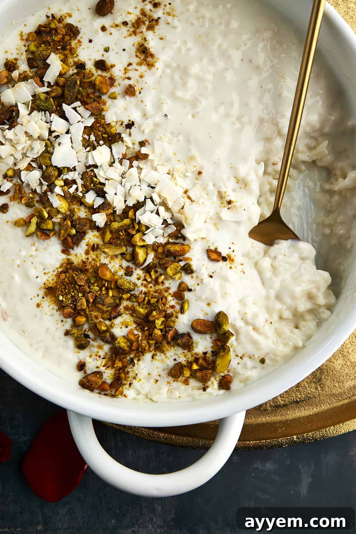 Ingredients for Roz Bil Laban laid out on a table, including milk, rice, sugar, cornstarch, and coconut cream.