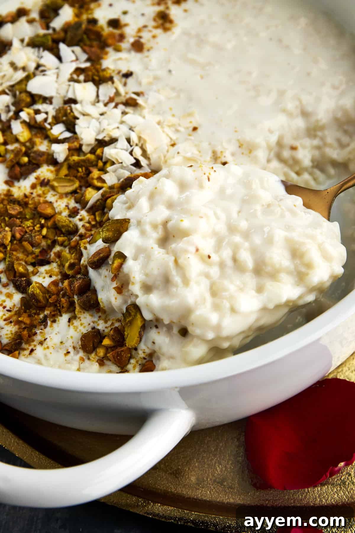 Close-up of Roz Bil Laban in a serving dish, garnished with pistachios.