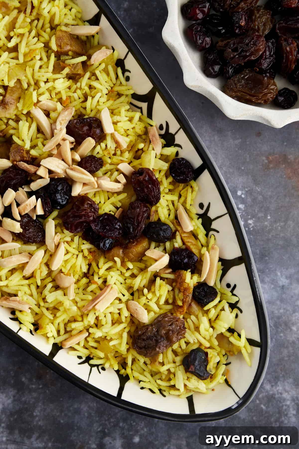 a platter of Persian jeweled rice with dried fruit and nuts, artfully arranged for a celebratory meal