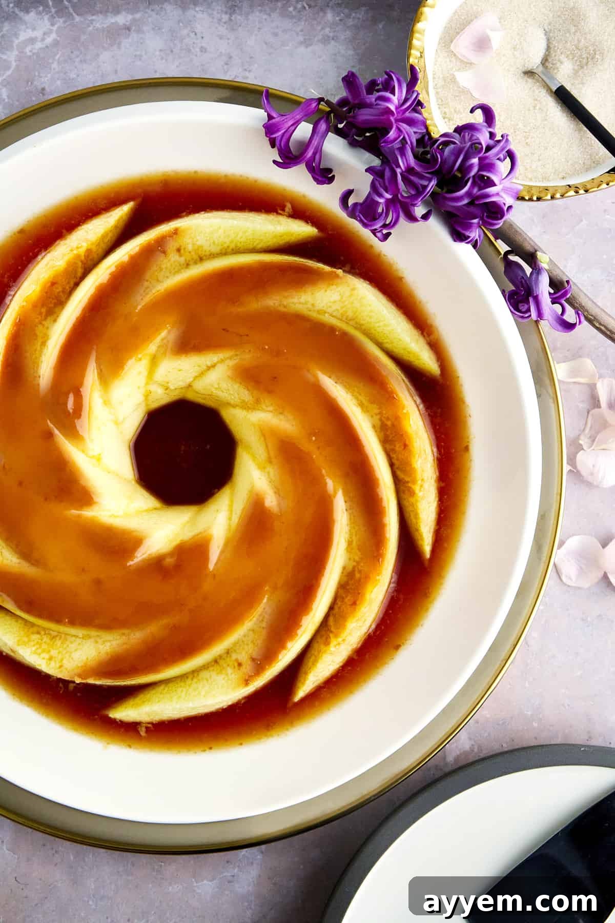Creme caramel topped with caramel on a plate.
