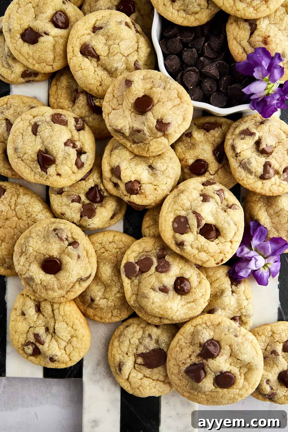 A large rustic platter filled with freshly baked mini chocolate chip cookies, ready to be enjoyed.