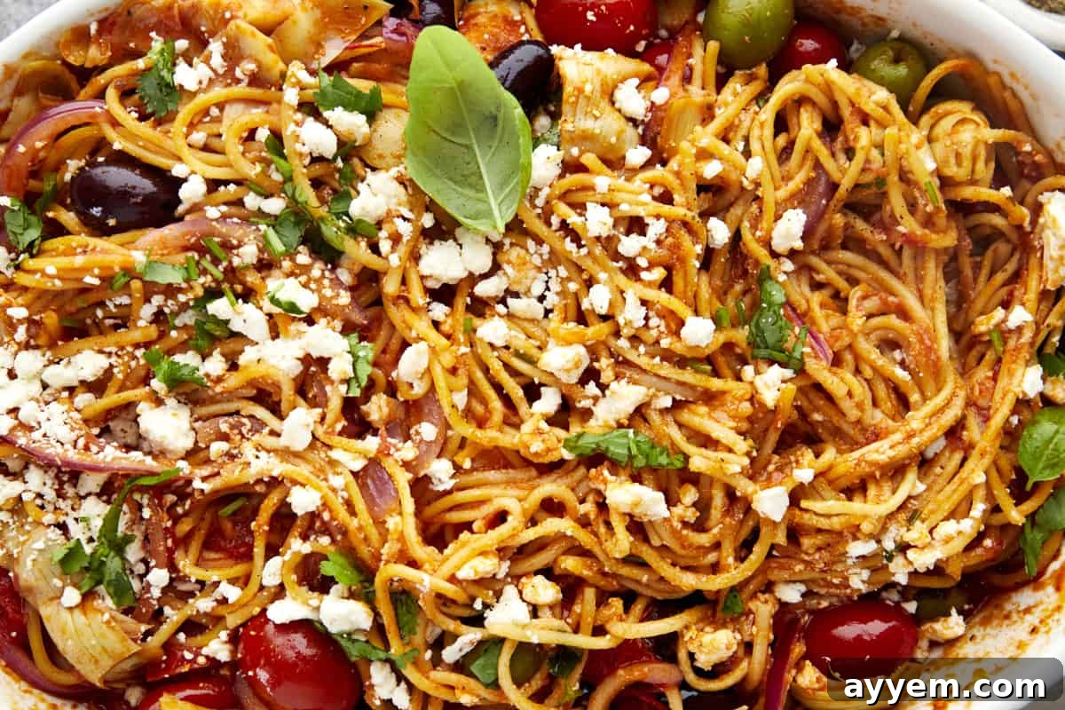Rustic Mediterranean Spaghetti Casserole 4 Close-up of baked Mediterranean spaghetti garnished with feta and parsley