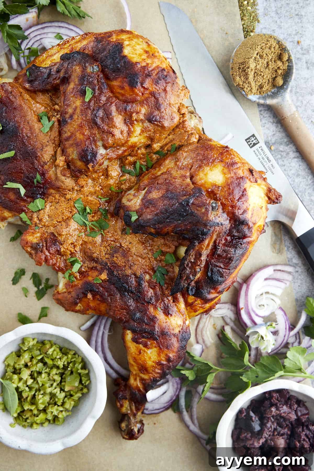 The Art of Roasting a Whole Chicken 2 Overhead image of a Middle Eastern spiced roasted whole chicken, golden brown and garnished with fresh herbs.