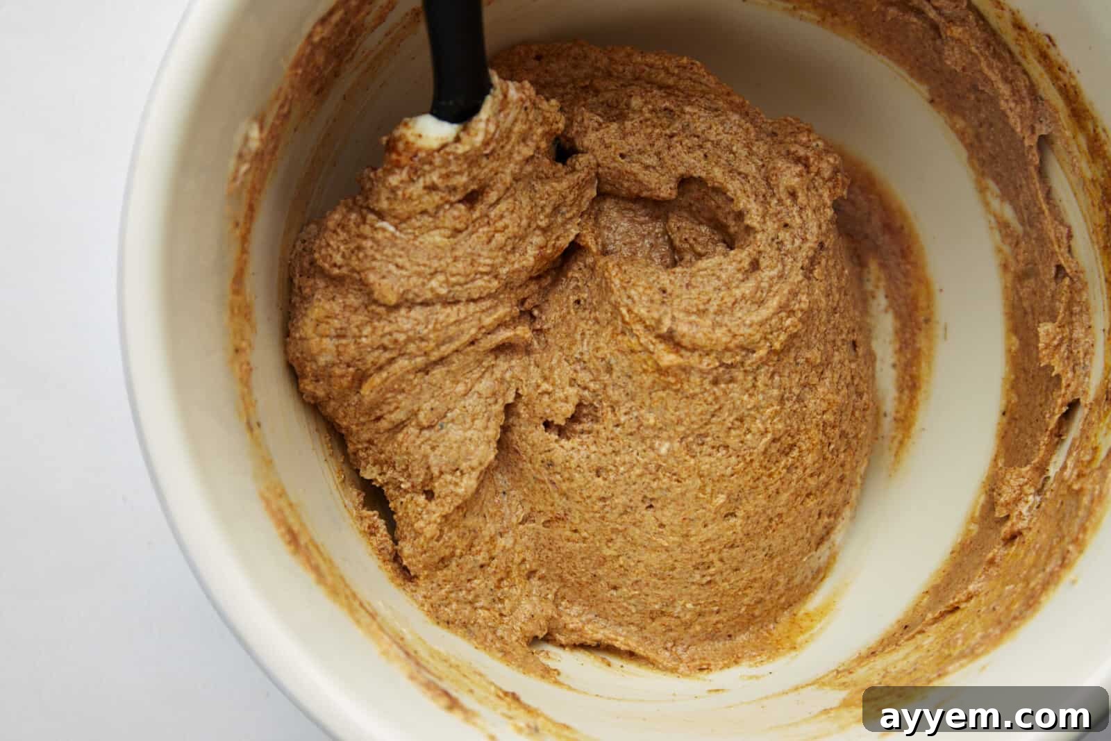 The Art of Roasting a Whole Chicken 8 A Middle Eastern spice and yogurt marinade being stirred until smooth in a mixing bowl.