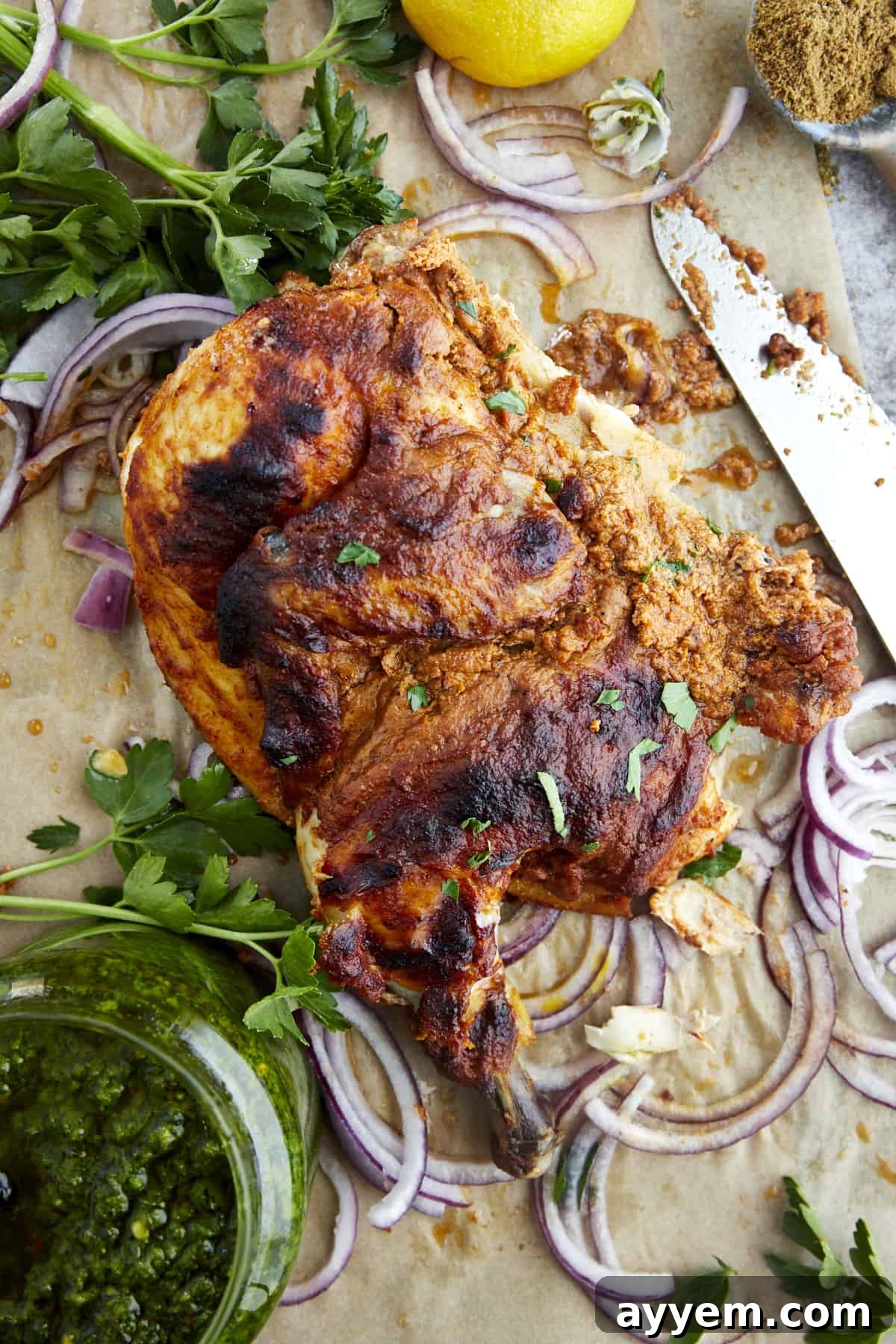 The Art of Roasting a Whole Chicken 10 A piece of a roasted whole chicken with warm Middle Eastern spices, served on a plate with herbs.