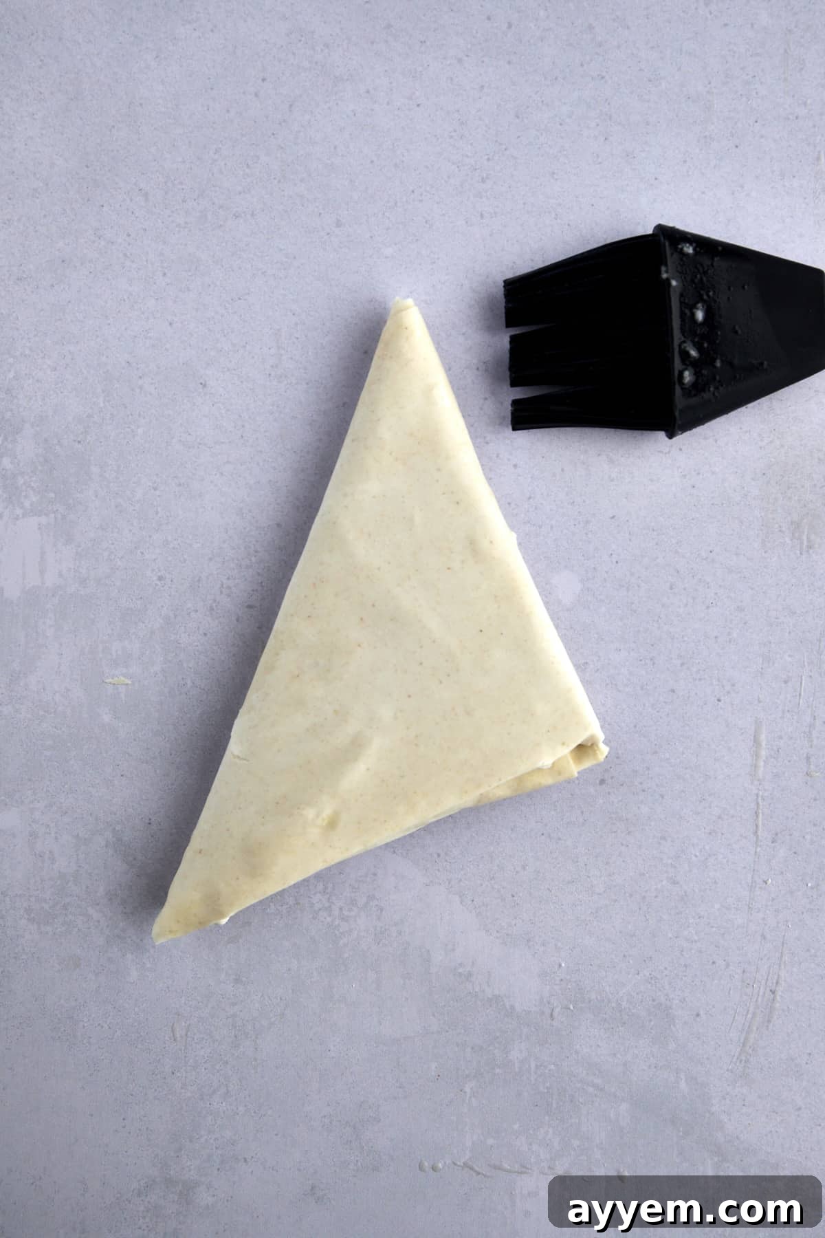 A triangle of raw phyllo dough. 