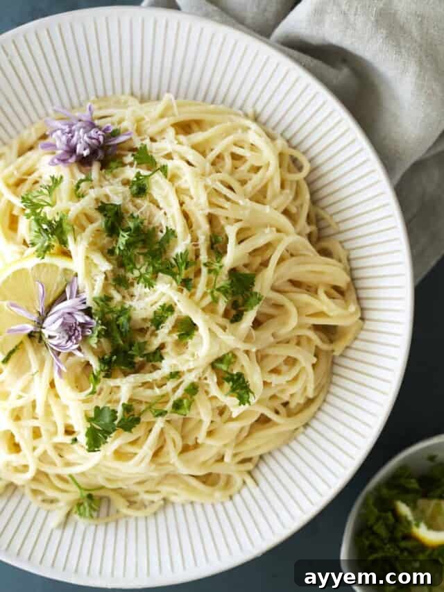 Easter Feast Over 25 Essential Recipes for All Your Celebrations 11 A vibrant bowl of one-pot lemon pasta, freshly garnished with fragrant herbs, showcasing a simple yet elegant vegetarian main course.