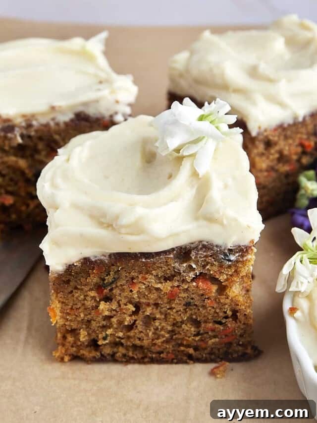 Easter Feast Over 25 Essential Recipes for All Your Celebrations 15 A perfectly square slice of easy carrot cake, generously topped with luscious cream cheese frosting, invitingly presented for an Easter dessert.