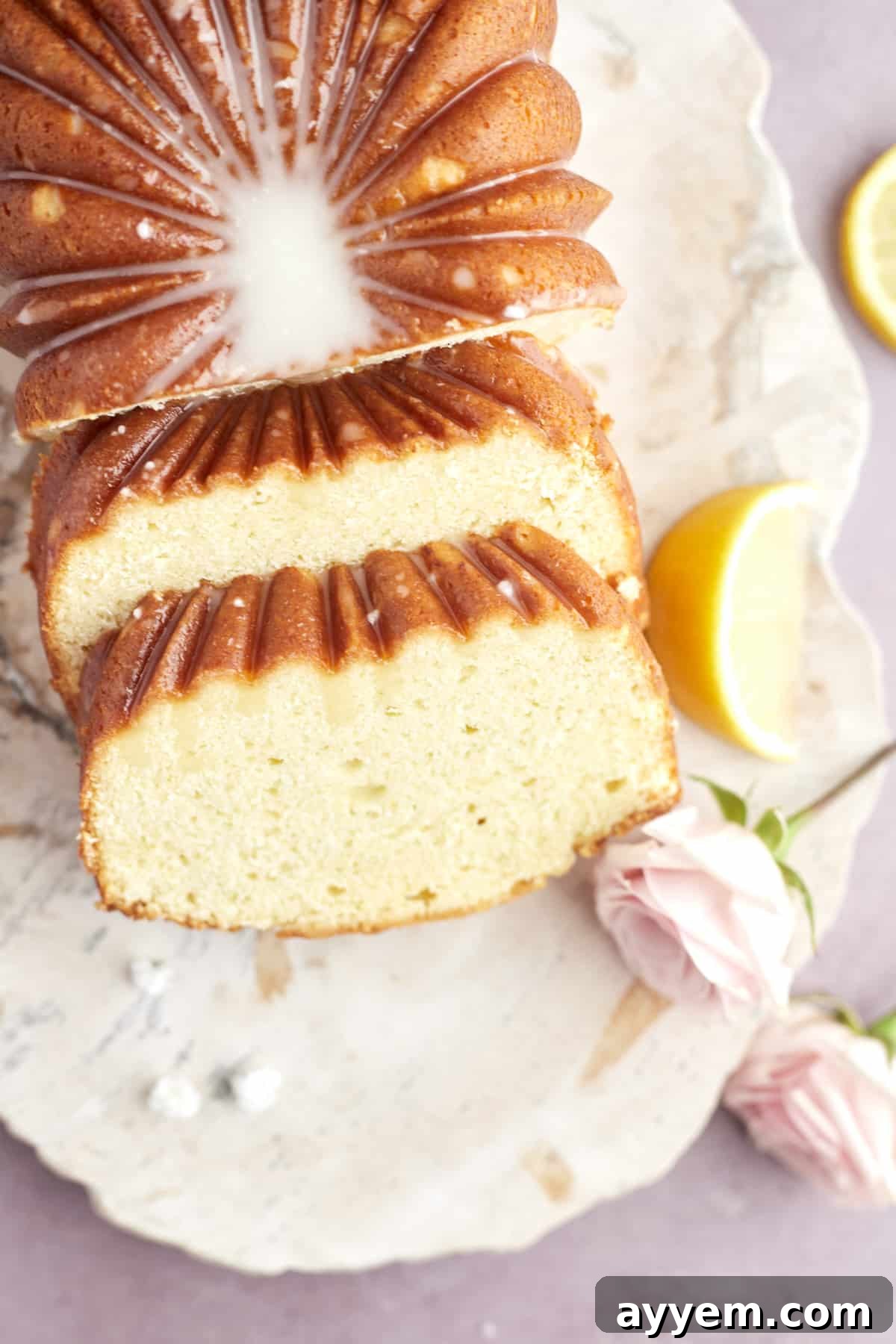 Easter Feast Over 25 Essential Recipes for All Your Celebrations 17 A beautifully glazed lemon loaf, with two enticing slices already cut, offering a zesty and sweet treat for any occasion.