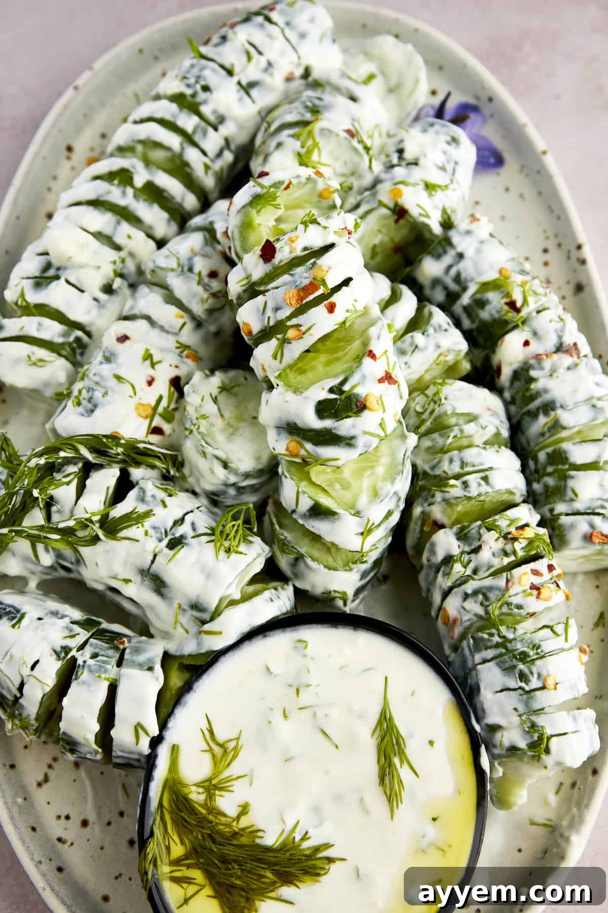 Easter Feast Over 25 Essential Recipes for All Your Celebrations 8 An artistic arrangement of spiraled cucumber yogurt salad, accompanied by a small bowl of creamy yogurt sauce, providing a refreshing and unique appetizer for any spring gathering.