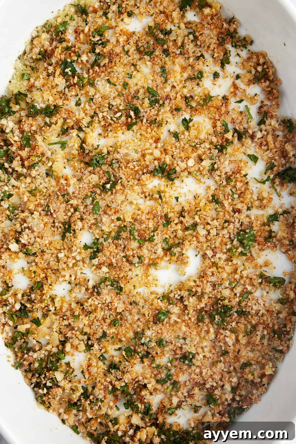 Breadcrumbs, butter, herbs, and spices in a 9x13 baking dish. 