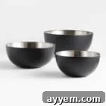 Three black stainless steel mixing bowls.